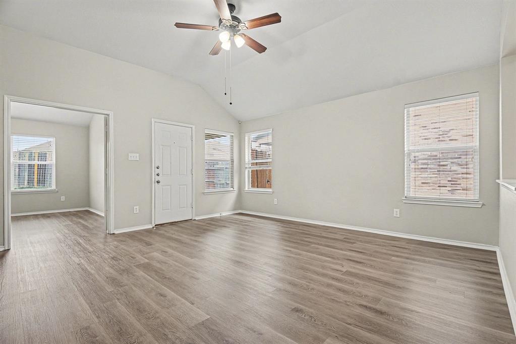 1021 Comfort Drive Forney, TX 75126 - Photo 12 of 37 a view of an empty room with a window and wooden floor