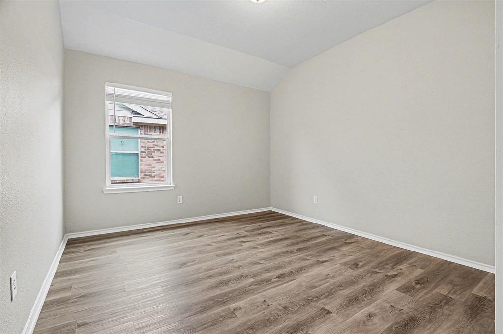 1021 Comfort Drive Forney, TX 75126 - Photo 23 of 37 a view of an empty room with wooden floor and a window
