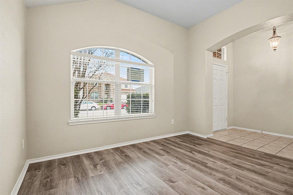 1021 Comfort Drive Forney, TX 75126 - Photo 6 of 37 an empty room with wooden floor and windows