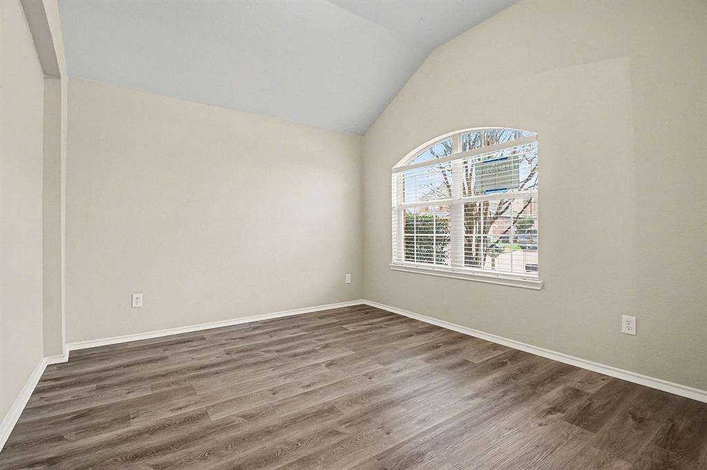 1021 Comfort Drive Forney, TX 75126 - Photo 7 of 37 an empty room with wooden floor cabinet and windows