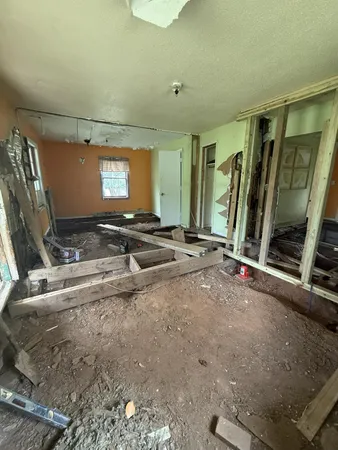 a bedroom with table and window