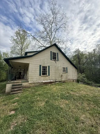 a house with green field in front of it