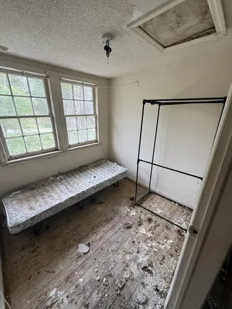 a bedroom with bed window and couch