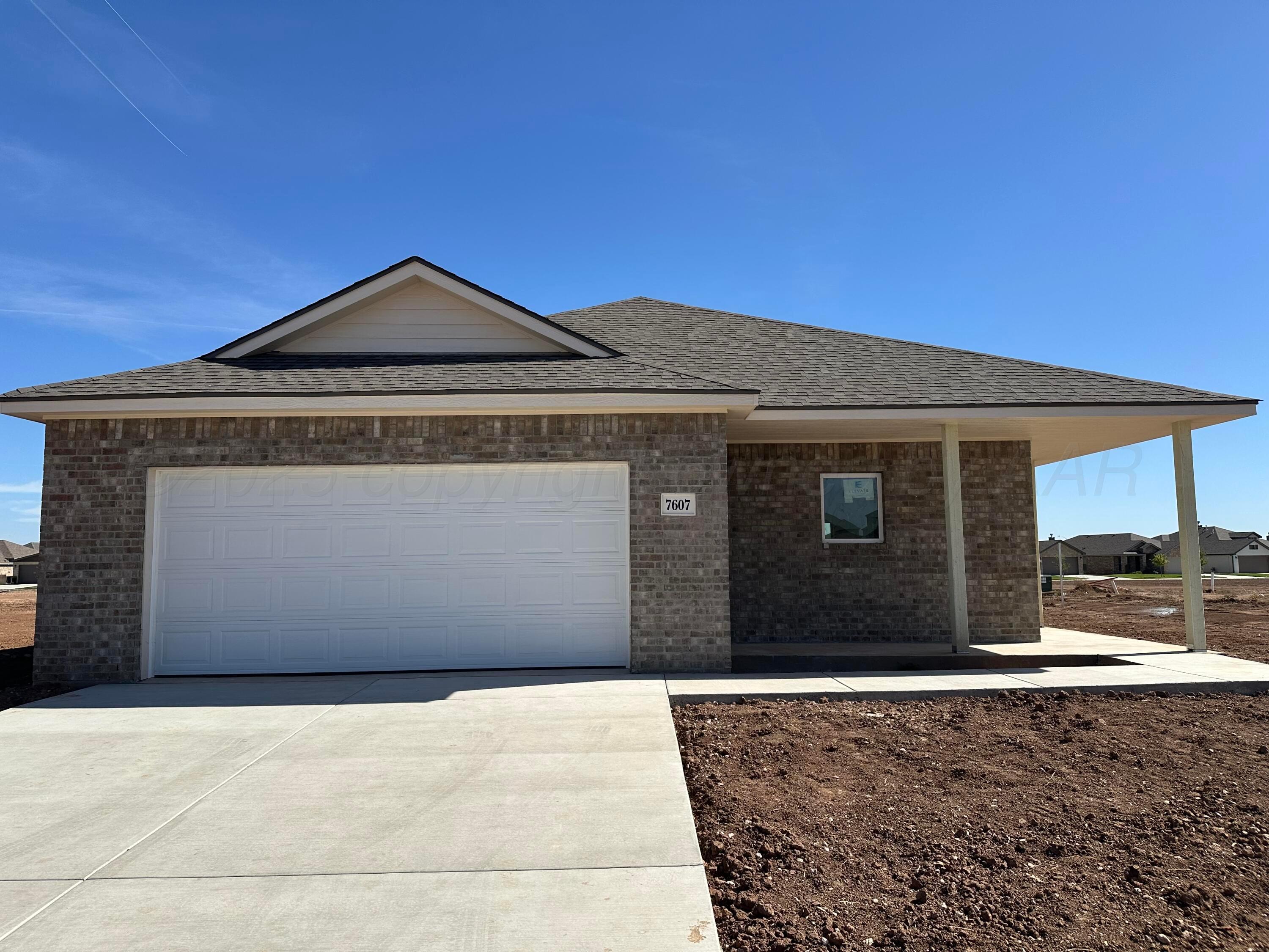 7607 Beck Drive Amarillo, TX 79119 - Photo 2 of 3 a front view of a house with a yard
