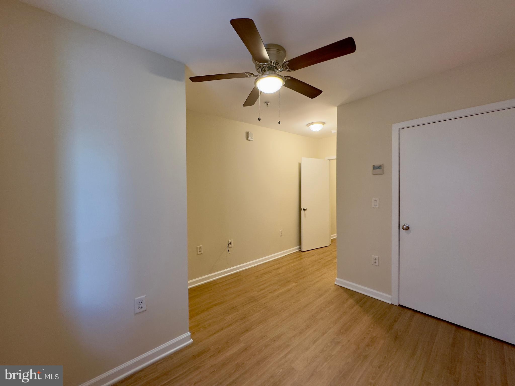 413 North Howard Street, Unit 204 Baltimore, MD 21201 - Photo 13 of 13 an empty room with wooden floor a ceiling fan and a window