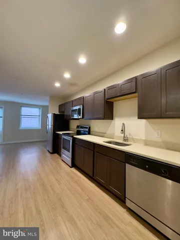 a kitchen with stainless steel appliances granite countertop a sink counter space and cabinets