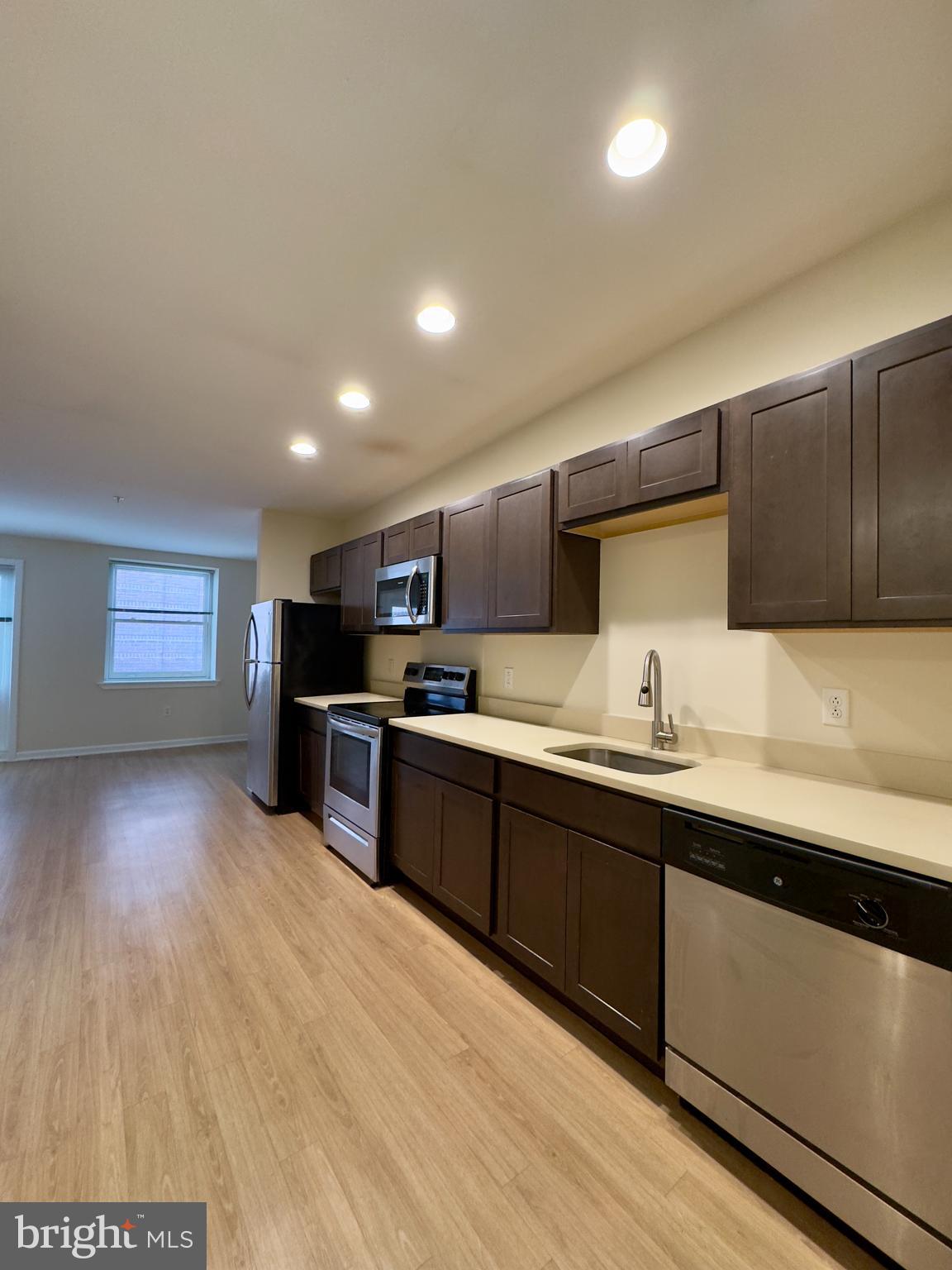 413 North Howard Street, Unit 204 Baltimore, MD 21201 - Photo 3 of 13 a kitchen with stainless steel appliances granite countertop a sink counter space and cabinets