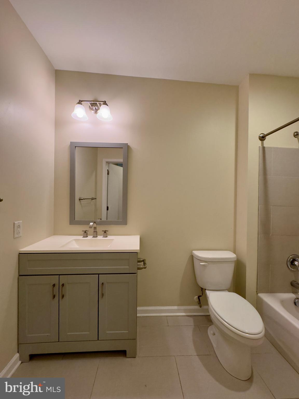 413 North Howard Street, Unit 204 Baltimore, MD 21201 - Photo 10 of 13 a bathroom with a toilet a sink and mirror