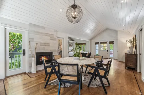 a kitchen with kitchen island granite countertop a sink a counter space appliances and cabinets