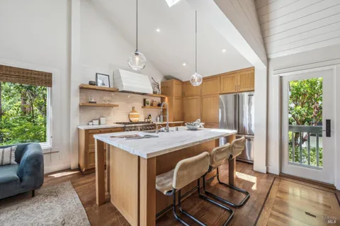 a kitchen with stainless steel appliances granite countertop a sink a stove and a refrigerator
