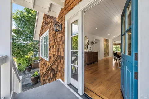 a view of a livingroom with furniture window and wooden floor