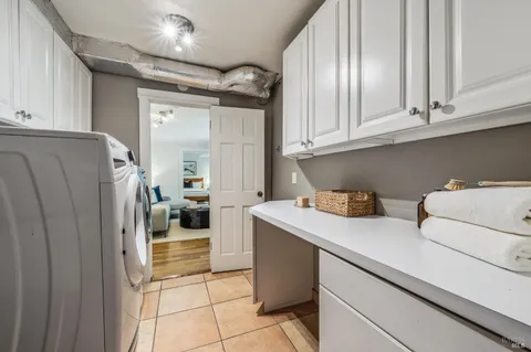 a view of a patio with couches table and chairs and potted plants