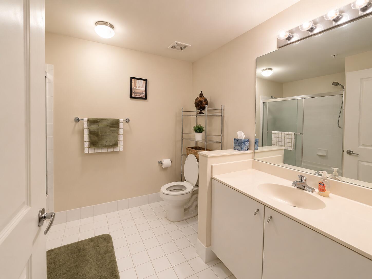 5880 West Sample Road, Unit 105 Coral Springs, FL 33067 - Photo 11 of 17 a bathroom with a toilet sink double vanity and mirror