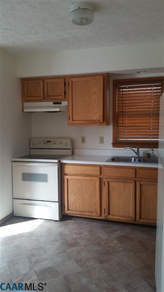 6601 Courthouse Road Louisa, VA 23093 - Photo 13 of 36 a kitchen with granite countertop white cabinets and white appliances