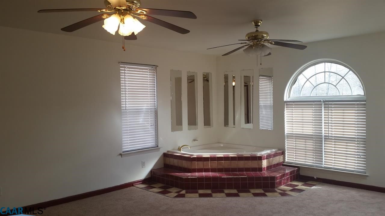 6601 Courthouse Road Louisa, VA 23093 - Photo 28 of 36 a bathroom with a window and chandelier