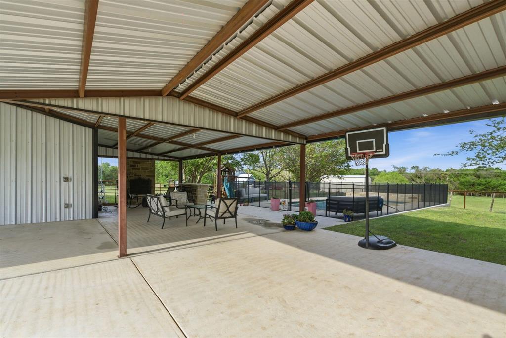 187 County Road 4195 Decatur, TX 76234 - Photo 7 of 40 a view of a patio with table and chairs and potted plants