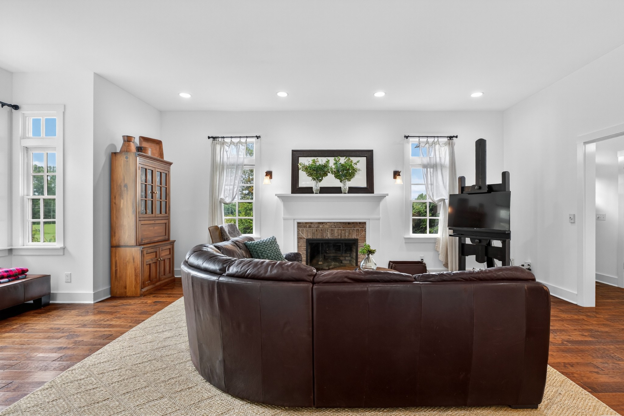123 Jones Road Taft, TN 38488 - Photo 12 of 87 a living room with furniture a fireplace and a flat screen tv