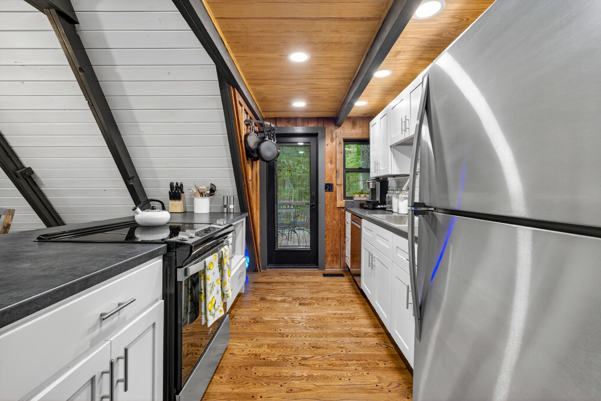 123 Jones Road Taft, TN 38488 - Photo 53 of 87 a kitchen with granite countertop a refrigerator a stove and a sink
