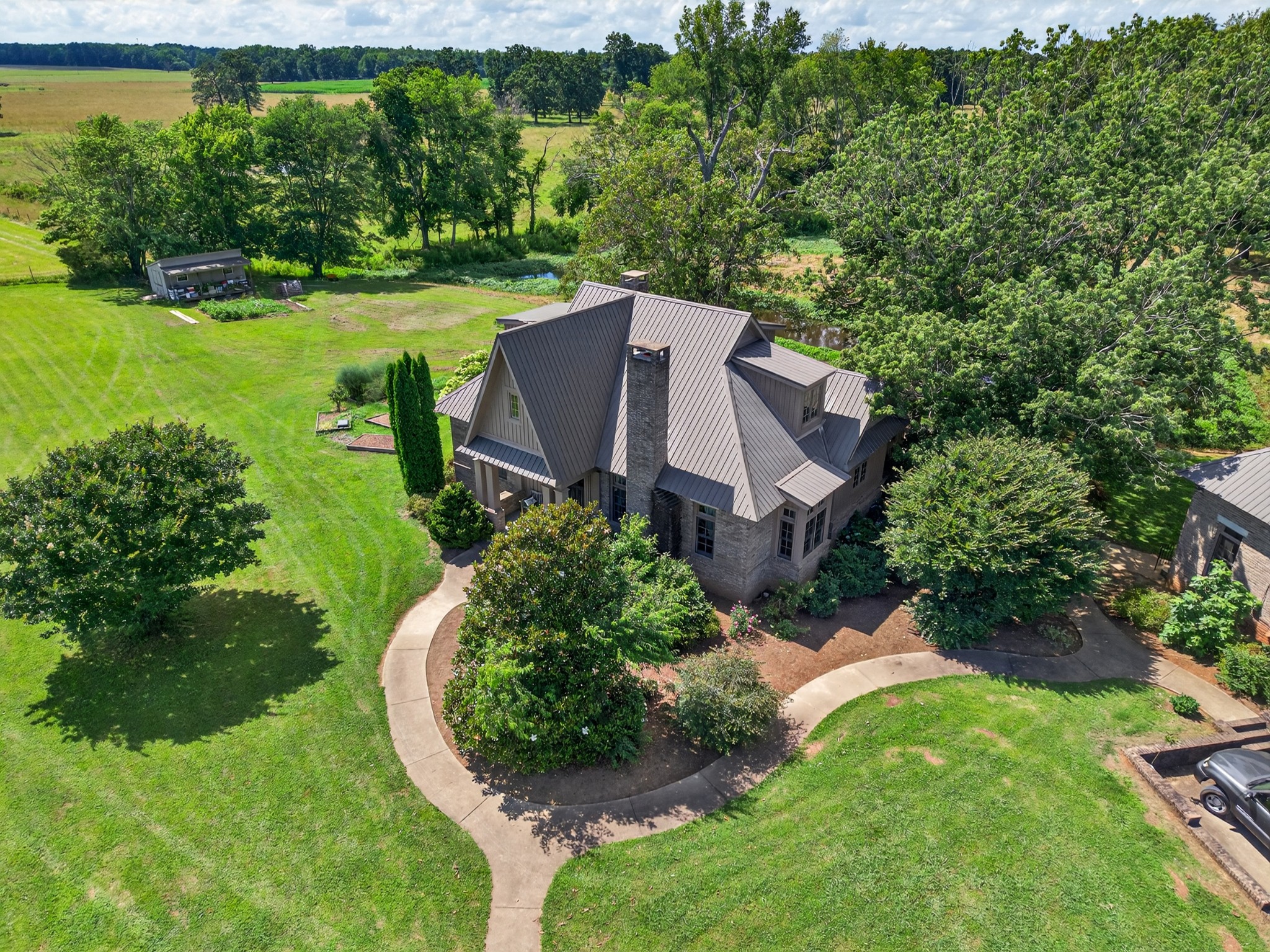 123 Jones Road Taft, TN 38488 - Photo 81 of 87 a view of a house with a big yard potted plants and large tree