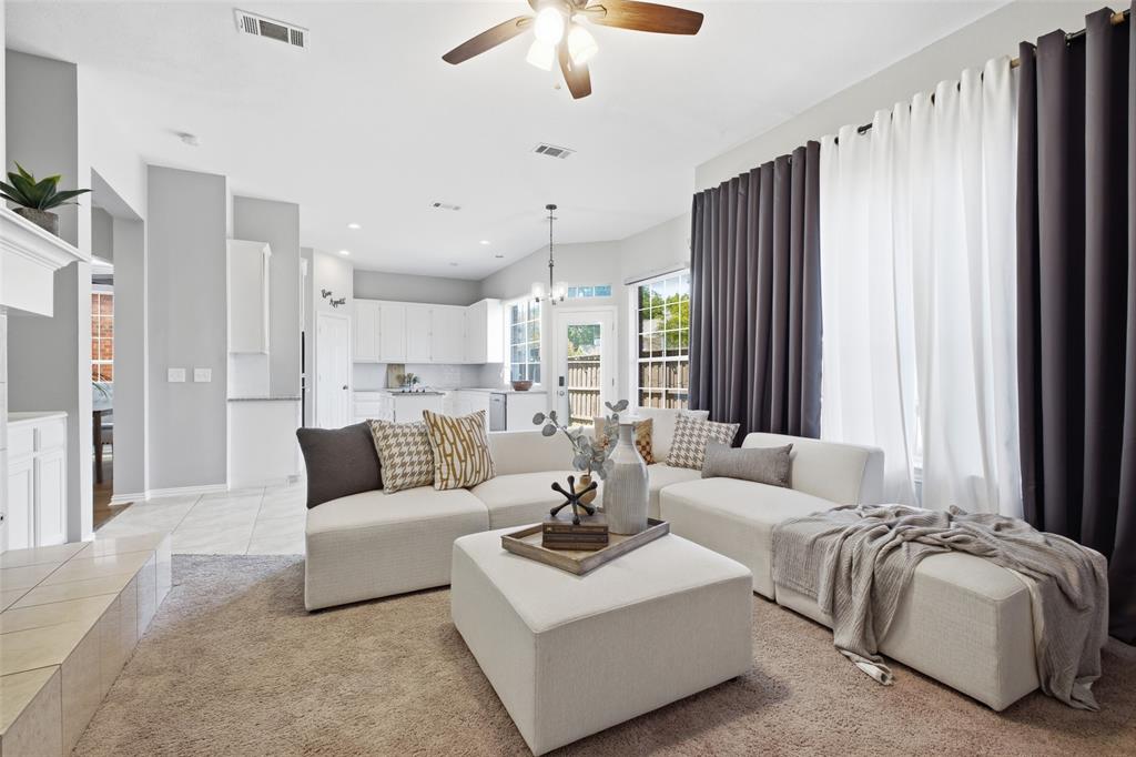 Generous windows flood the family room with natural light while framing a direct view into the kitchen and out to the backyard. The open layout keeps everyone connected whether you're cooking, relaxing, or hosting.