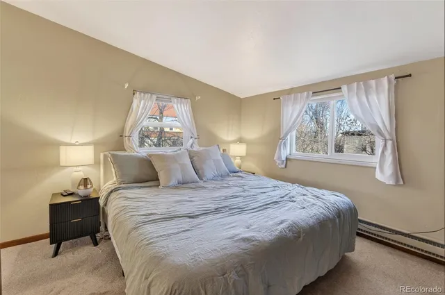 a bedroom with a large bed and a window