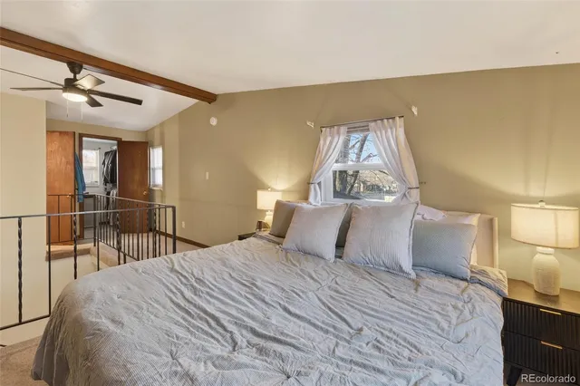 a bedroom with a bed and a lamp