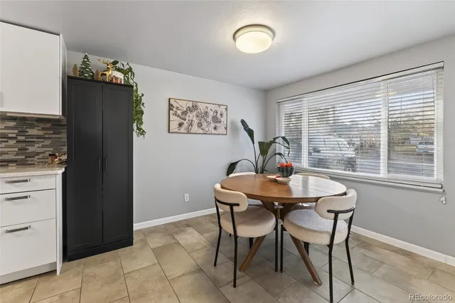 a view of a dining room with furniture and window