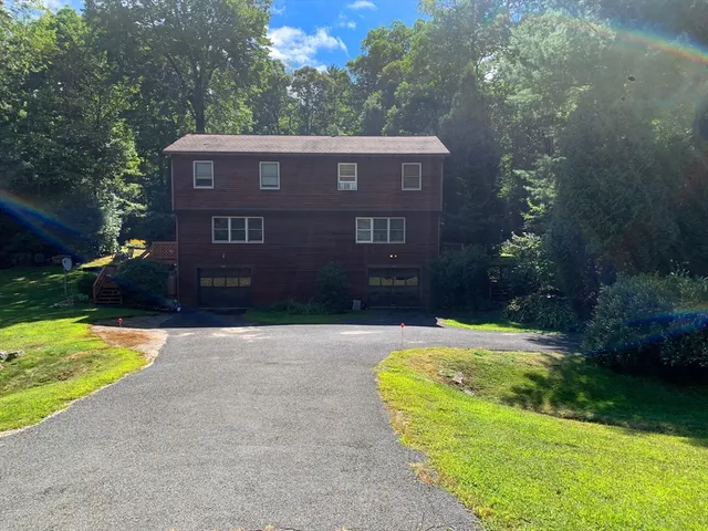 a view of a brick house with a yard