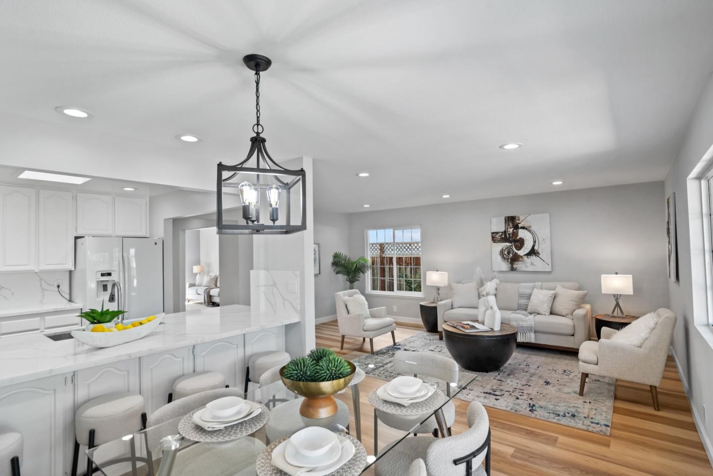 965 Buckeye Drive Sunnyvale, CA 94086 - Photo 12 of 27 a living room with furniture kitchen view and a wooden floor
