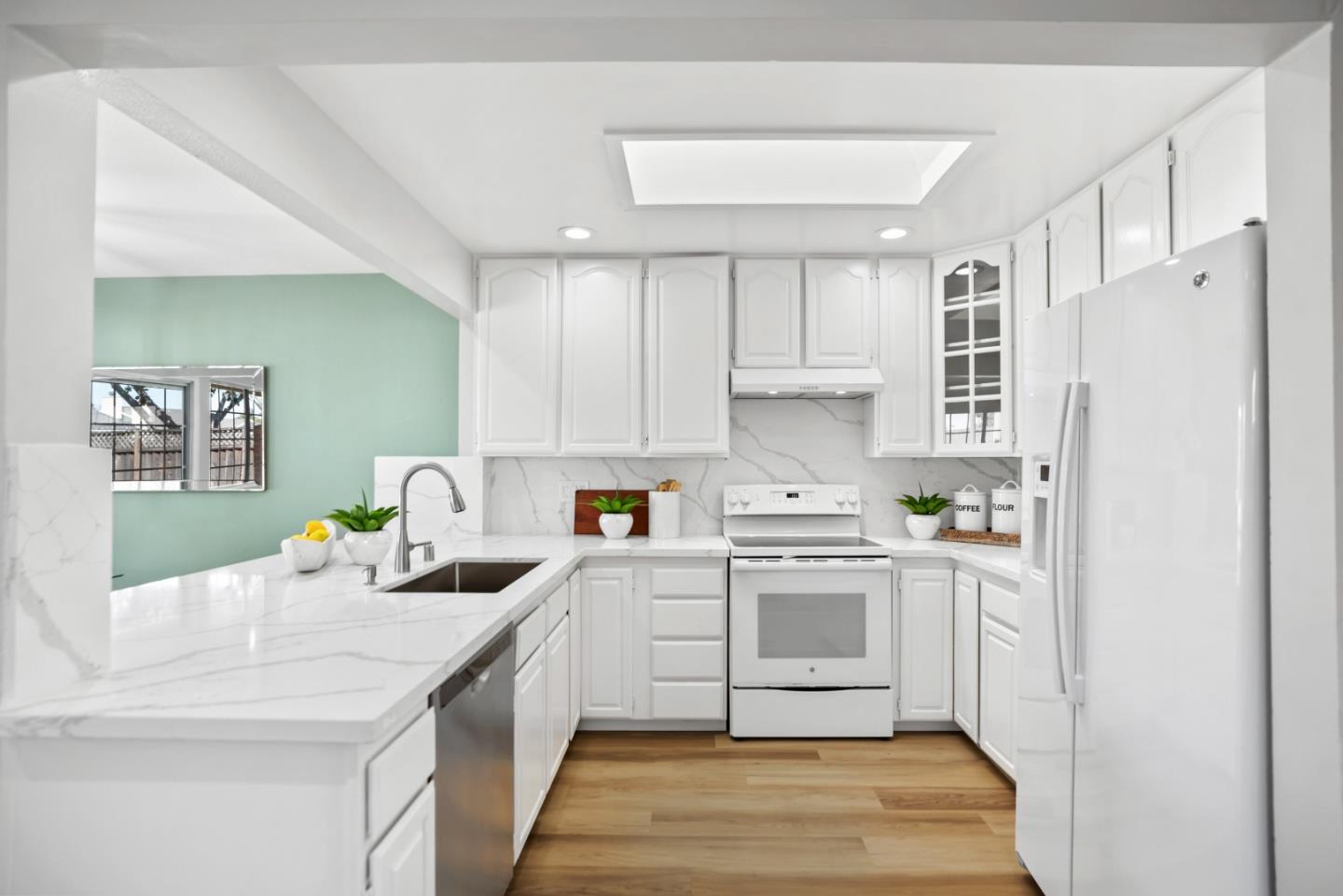 965 Buckeye Drive Sunnyvale, CA 94086 - Photo 13 of 27 a kitchen with a white stove top oven sink and white cabinets