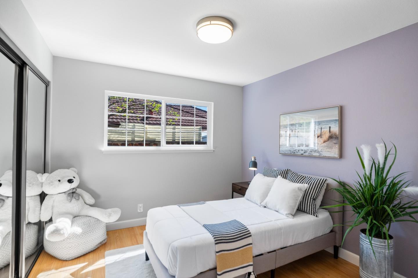 965 Buckeye Drive Sunnyvale, CA 94086 - Photo 21 of 27 a bedroom with a bed and wooden floor