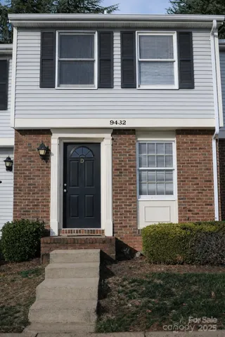 a view of a house with more windows and brick walls