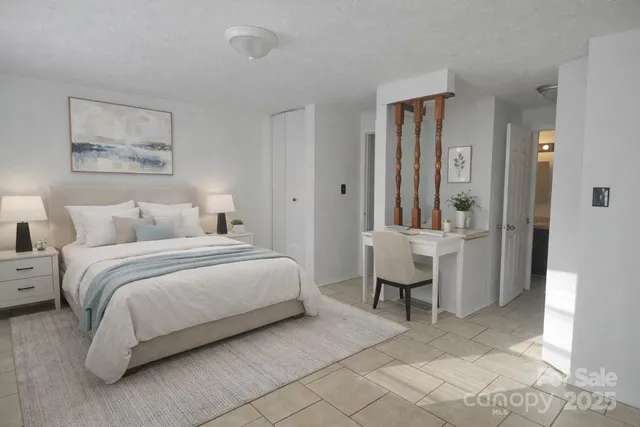 a bedroom with a bed and a chair