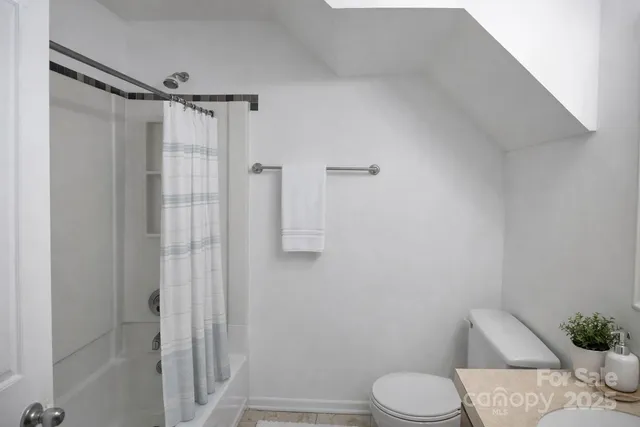 a bathroom with a toilet and shower