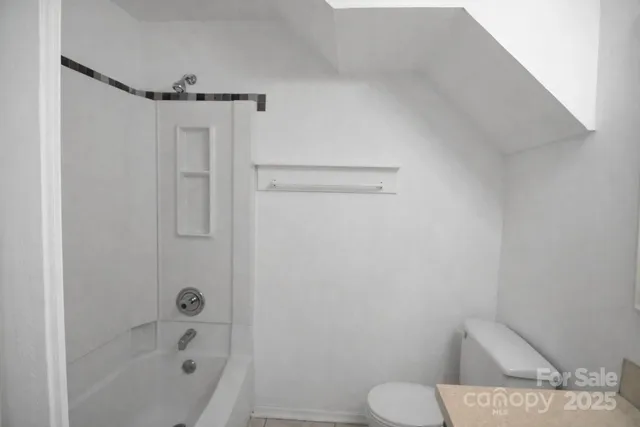 a bathroom with a shower and toilet