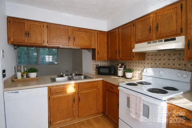 a kitchen with a sink a stove and cabinets