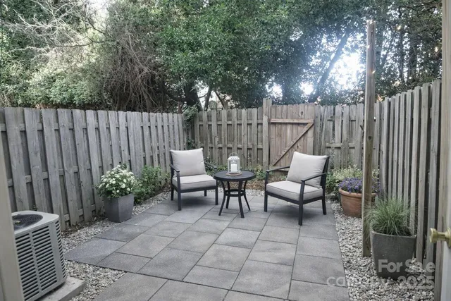 a view of a chairs and tables in the back yard of the house