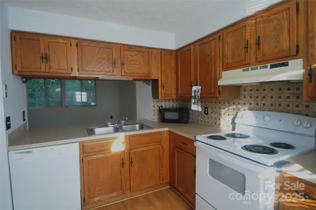 a kitchen with a sink cabinets and appliances