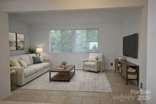 a living room with furniture and a flat screen tv