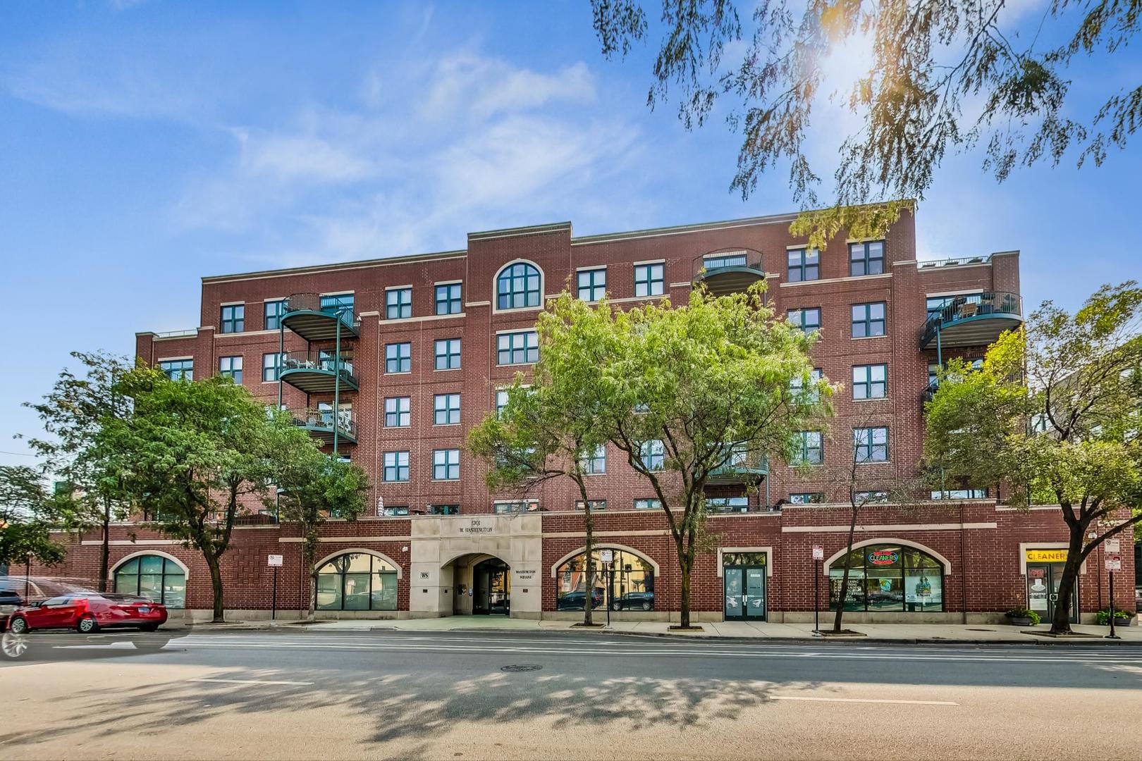 1301 West Washington Boulevard, Unit 208 Chicago, IL 60607 - Photo 1 of 37 a front view of a building with lot of cars and trees