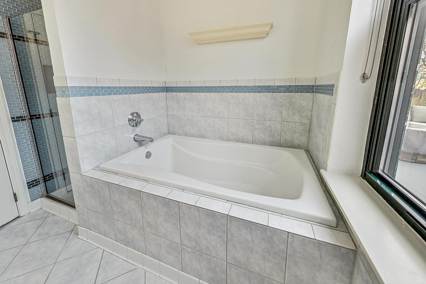 1301 West Washington Boulevard, Unit 208 Chicago, IL 60607 - Photo 20 of 37 a bath tub sitting next to a sink