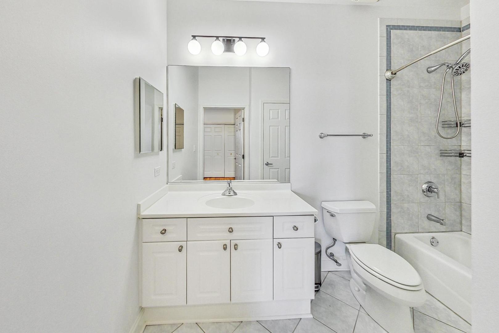 1301 West Washington Boulevard, Unit 208 Chicago, IL 60607 - Photo 25 of 37 a bathroom with a sink toilet vanity and shower