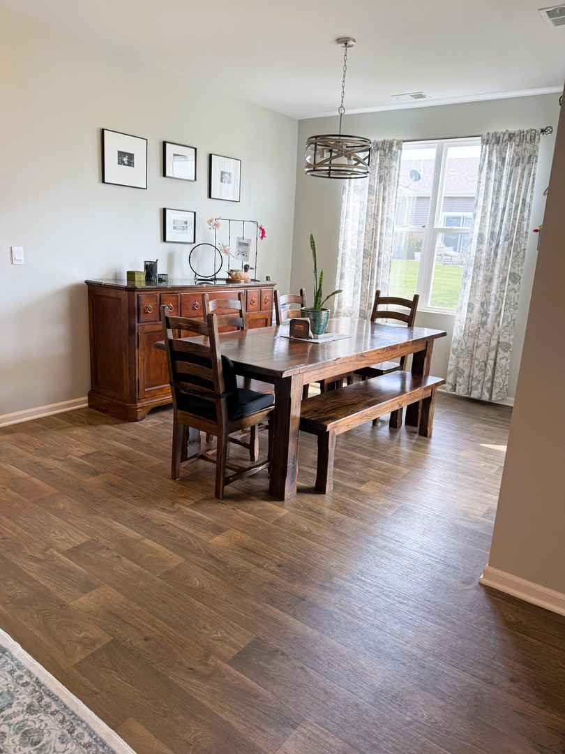 6323 Aspen Lane Wonder Lake, IL 60097 - Photo 4 of 17 a view of a dining room with furniture window and wooden floor