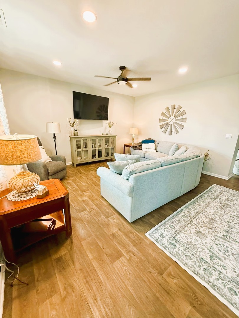 6323 Aspen Lane Wonder Lake, IL 60097 - Photo 7 of 17 a living room with furniture and a flat screen tv