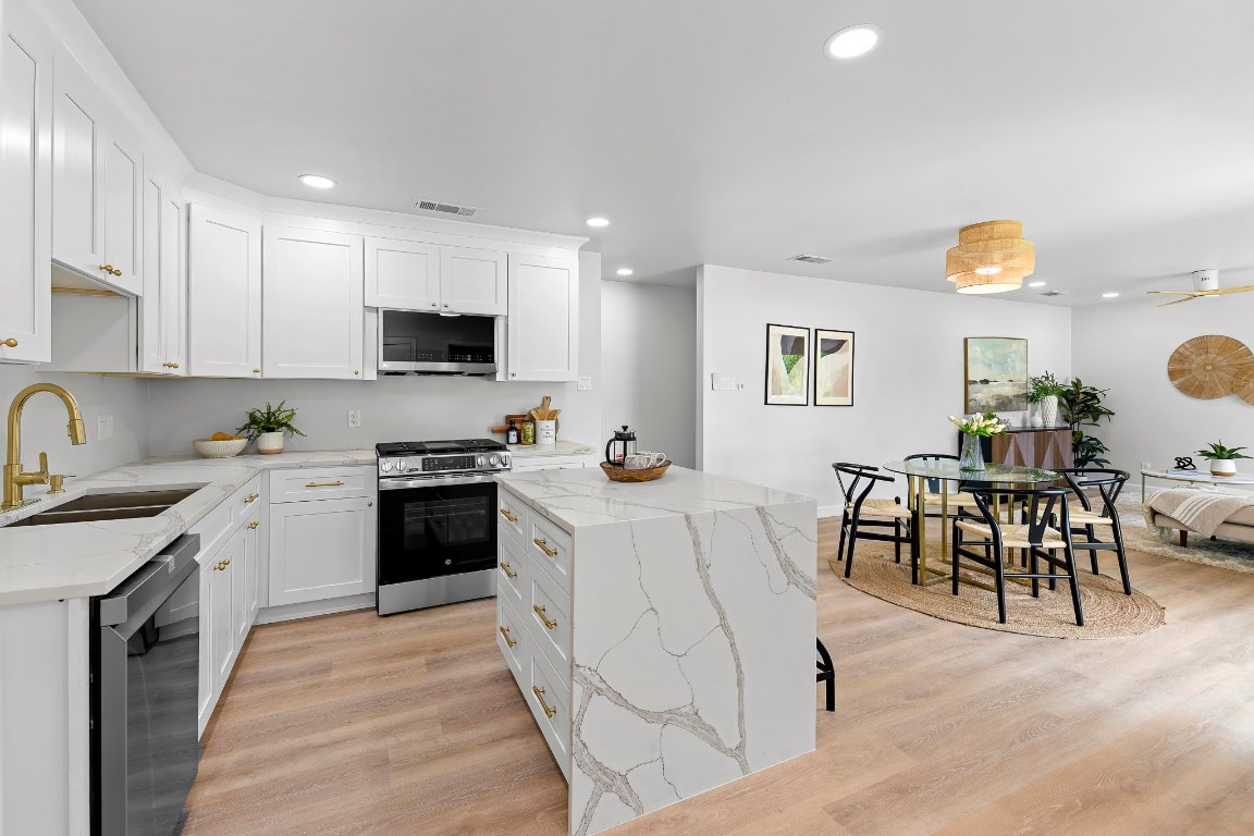 7302 Hartnell Drive Austin, TX 78723 - Photo 1 of 1 a kitchen with a table chairs sink and cabinets