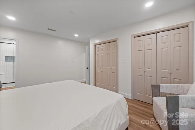 a bedroom with a bed and a bathroom