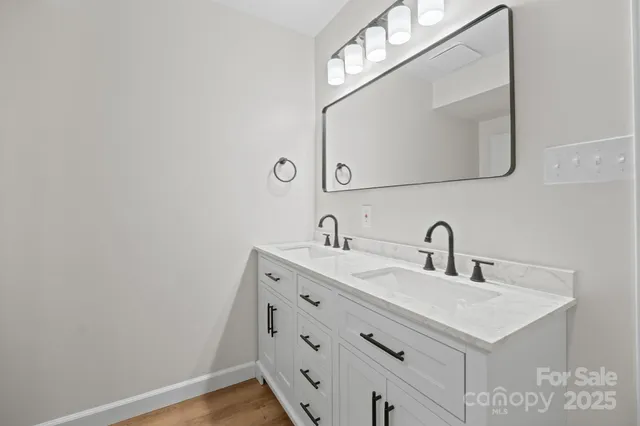 a bathroom with a sink vanity and a mirror