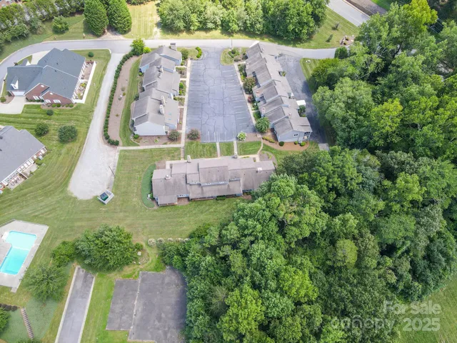 an aerial view of a house with outdoor space pool seating area and yard