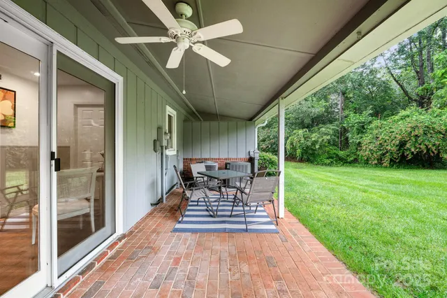 a view of a porch with furniture and garden