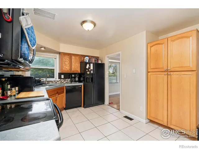 a kitchen with a refrigerator and a counter